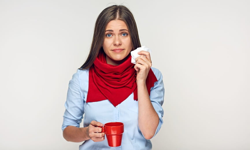Sickness woman holding red cup and paper tissue