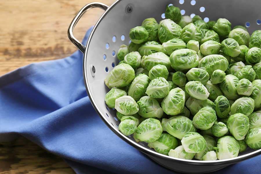 Brussels sprouts in colander on napkin